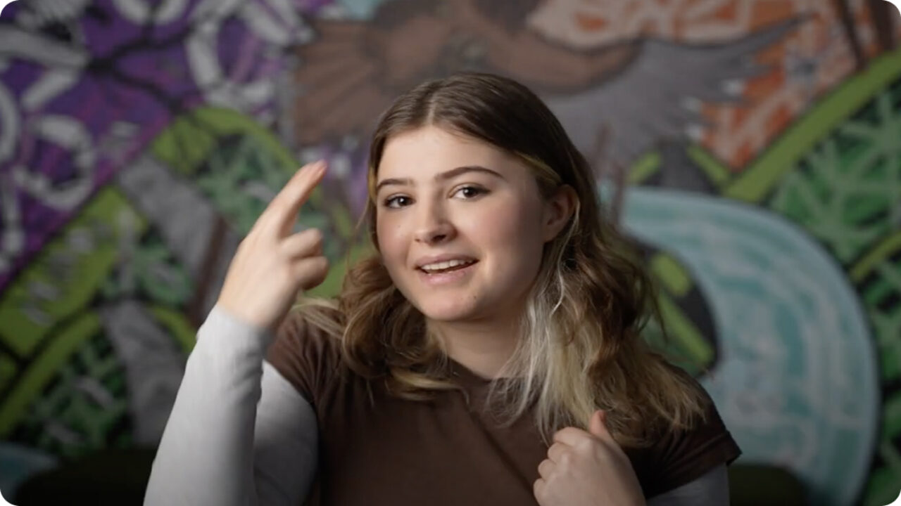 White young person using Auslan