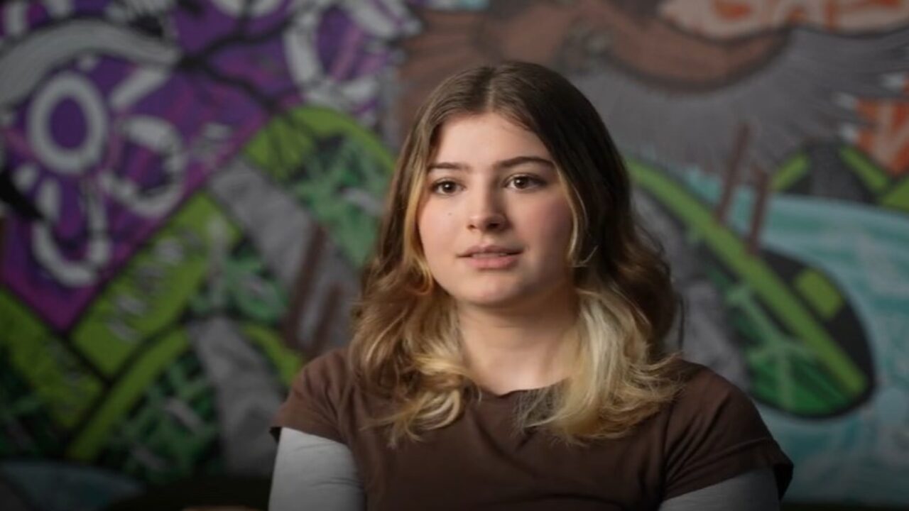 Photo of a disabled young person looking at the camera