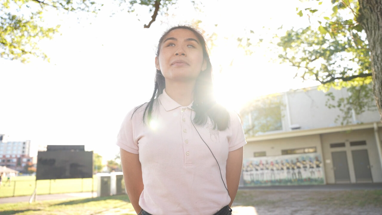 Photo of a young Asian woman standing outside